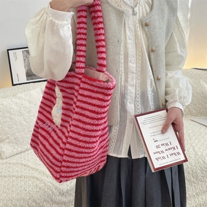 Close-up of red and pink striped plush tote bag with cute 3D cartoon animal patch