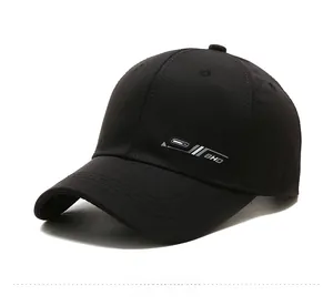 Detail of a black baseball cap with BHD side logo and classic curved brim design