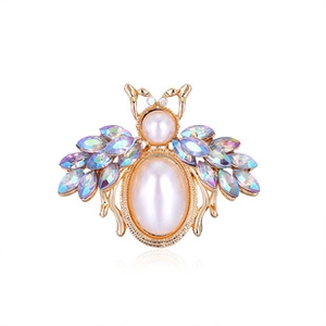 Macro shot of bee brooch with oval pearl body and iridescent rhinestone wings