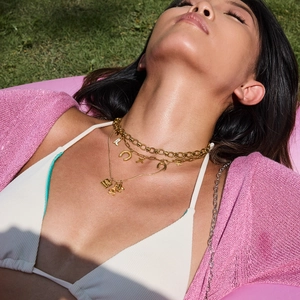 Close-up of a layered 18K gold plated stainless steel necklace on a relaxed model