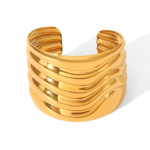 Minimalist wide gold wavy texture stainless steel open bangle with a polished mirror finish
