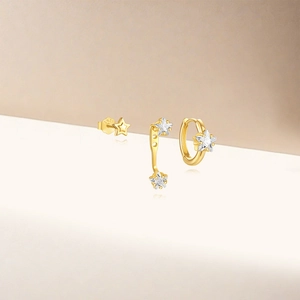 Macro view of gold S925 sterling silver star stud earring set with sparkling zircon stones
