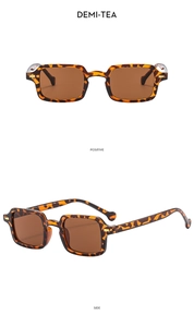 Macro detail of vintage tortoise shell square sunglasses with golden metal hinges
