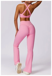 Rear view of pink yoga set with cross-back sports bra and high-waist flared pants