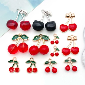 Detailed view of assorted cherry pendants in red and black alloy for DIY jewelry