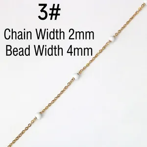 Detail of 2mm golden stainless steel chain with 4mm white beads for DIY jewelry