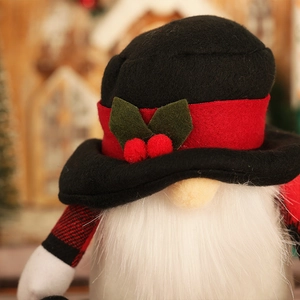 Close-up of a Nordic Christmas gnome with a black hat, red berries, and a long white beard
