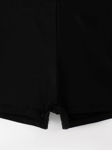 Macro shot of high-elasticity black tankini shorts showing precise stitching and fabric texture