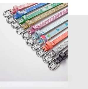 Detailed view of colorful glitter belts with silver metal buckles in various vibrant shades