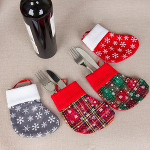 Festive Christmas mini stocking cutlery holders with snowflake and plaid fabric patterns