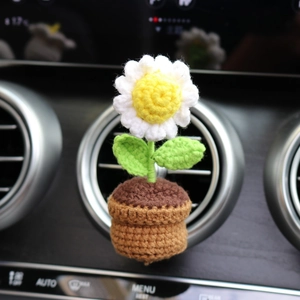 Handmade crochet daisy flower car vent clip with white petals in a brown pot
