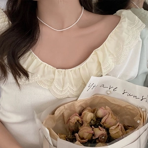 Elegant pearl necklace on model neck featuring a minimalist single strand design