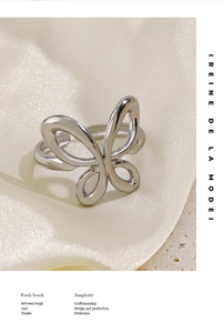 Macro detail of a 18K gold-plated butterfly ring with polished hollow wing design