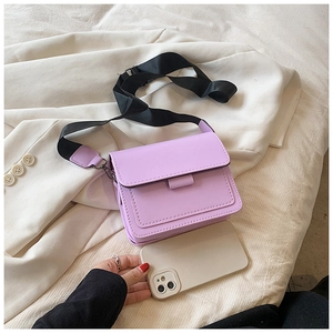 Purple small square crossbody bag with adjustable strap shown with a smartphone for size scale