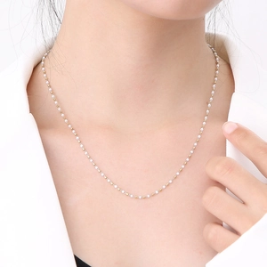 Elegant gold and white beaded stainless steel chain necklace for women on model
