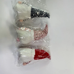 Detailed view of three Christmas gnomes individually packed in transparent bags
