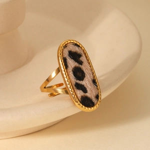 Close-up of leopard print oval inlay on a gold-plated stainless steel ring
