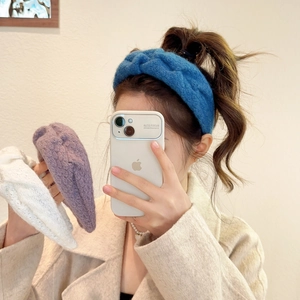 Macro detail of soft cable knit wide headbands in blue, purple, and white colors