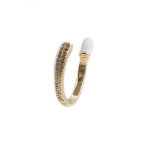 Detailed macro view of the open gold ring with sparkling micro-inlaid zircon and white enamel