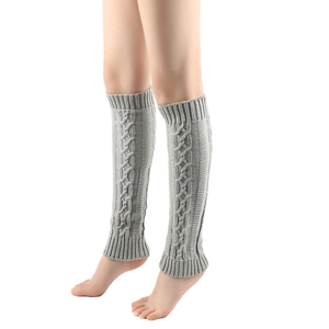 Close-up of light gray knit leg warmers with classic cable knit texture and ribbed cuffs