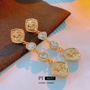 Vintage lion coin drop earrings in gold finish with sparkling zircons and tassels