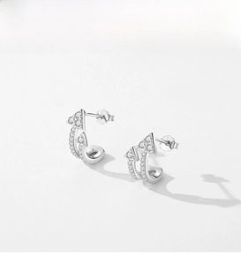Macro shot of S925 sterling silver stamp on minimalist double arrow earrings with pavé zircons