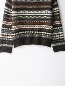Detailed view of vintage Fair Isle knit sweater with ribbed cuffs and hemline pattern