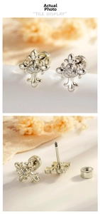 Detail view of vintage rose cross earrings with screw back and sparkling zircon stone