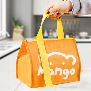 Insulated orange lunch bag with a cute cartoon bear print and convenient hand straps