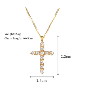 Detail view of gold cross necklace with crystal pavé and size measurements info