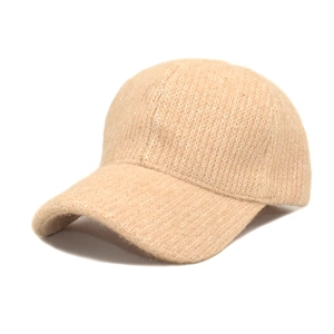 Detail of beige knit baseball cap with shimmering sequins and warm plush texture
