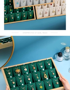Bamboo wood jewelry tray with velvet lining showing various necklace pendants and colors
