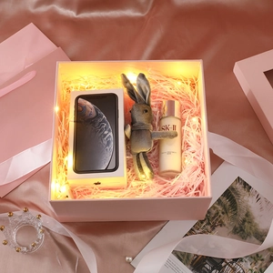 Pink square gift box with shredded paper, LED lights and silk background detail