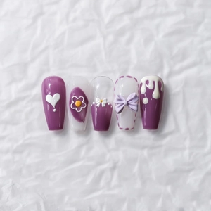 3D embossed purple heart and bow press-on nails with cream drip effect on white background