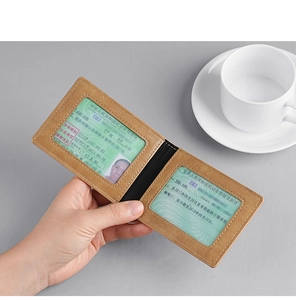 Close-up of light brown slim wallet with dual transparent ID windows and stitching