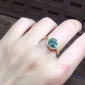 3-carat blue-green moissanite halo ring with gold plating and paved diamond accents