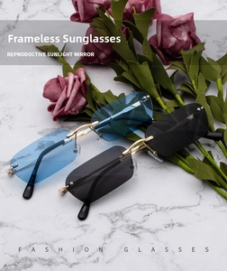 Detail of rimless rectangle sunglasses with blue and grey lenses on marble background