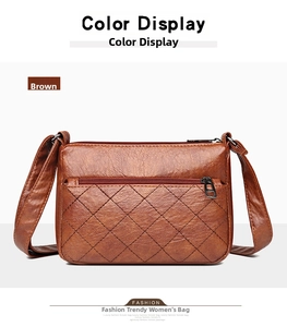 Detailed front view of brown leather crossbody bag with quilted diamond pattern