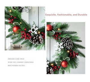 Detail of Christmas wreath with pine needles, red berries, pinecones and warm LED lights