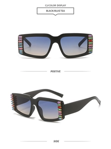 Detail of square oversized sunglasses with black frame and colorful rhinestone decor