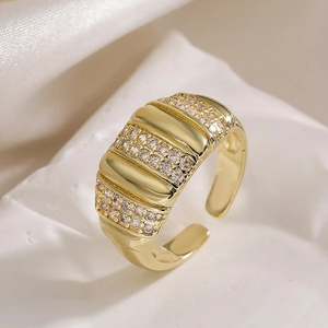 Macro shot of 18K gold plated wide band ring featuring micro-pave cubic zirconia rows