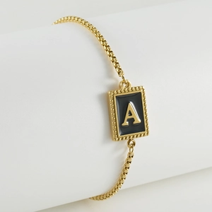 Adjustable stainless steel 18K gold plated bracelet featuring black enamel letter A charm