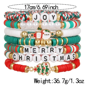Flat lay of red and green beaded Christmas bracelets with JOY and MERRY CHRISTMAS charms