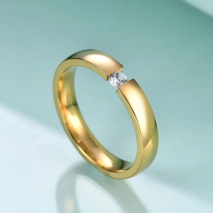 Detail of a 3mm gold stainless steel ring featuring a single clear cubic zirconia inlay