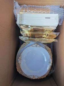 Bulk gold rimmed white disposable plates with plastic cutlery set in shipping box