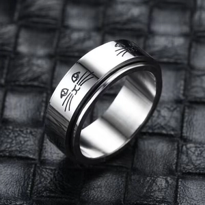Detail shot of rotatable stainless steel stress relief ring with engraved cat face