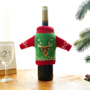 Knitted Christmas wine bottle cover featuring a reindeer pattern in festive red and green