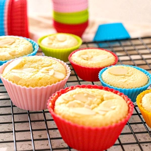 Close-up of colorful silicone muffin cups with almond sponge cakes inside