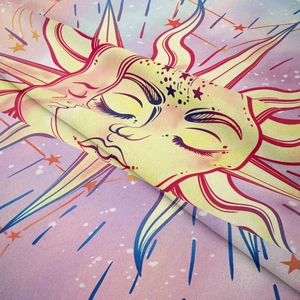 Close-up of Bohemian tapestry fabric showing sun and moon pattern in pink and yellow