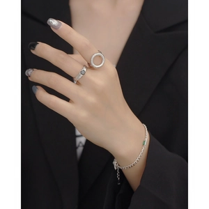 Close-up of S925 silver rings and bracelet featuring irregular foil texture and gems